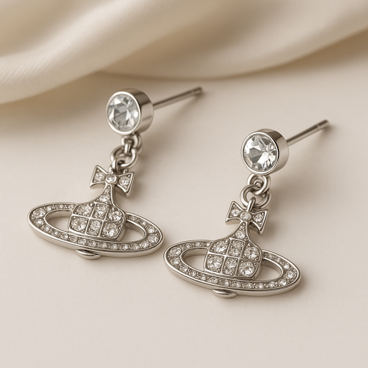 Cosmic orbit silver rhinestone earrings with bow and planet design – inspired by Y2K & space aesthetic