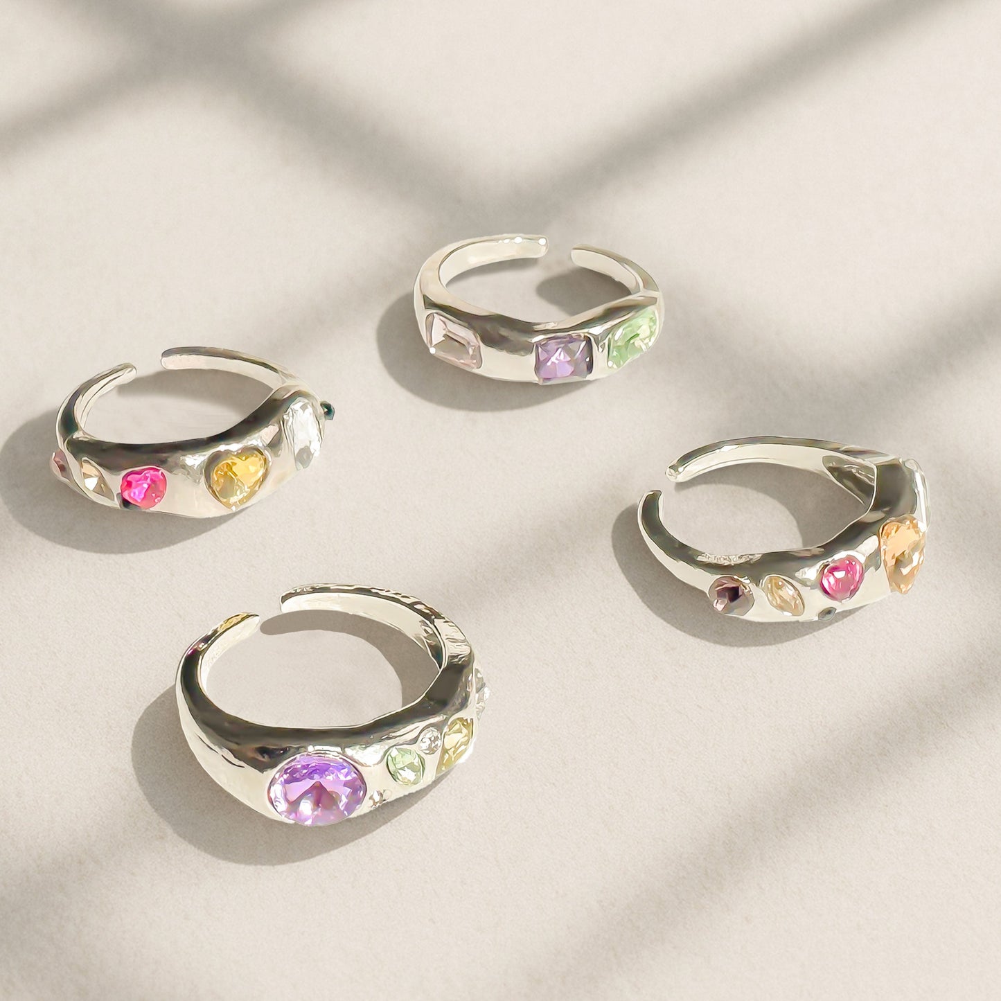 Chrome silver Y2K rings with colorful simulated gems in open adjustable design, candy-colored statement ring styled for tiktok, streetwear and gen Z fashion