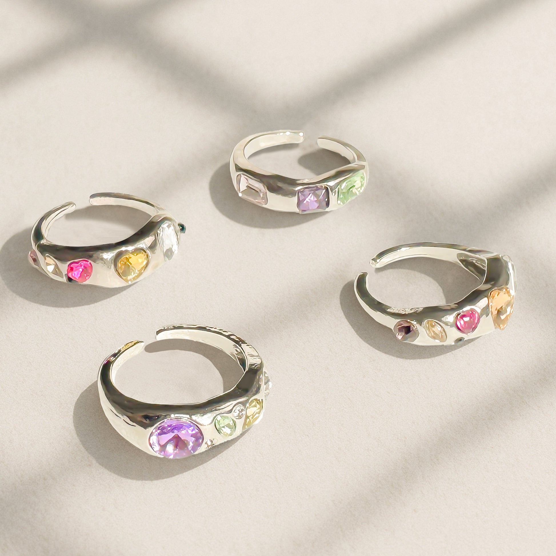 Chrome silver Y2K rings with colorful simulated gems in open adjustable design, candy-colored statement ring styled for tiktok, streetwear and gen Z fashion