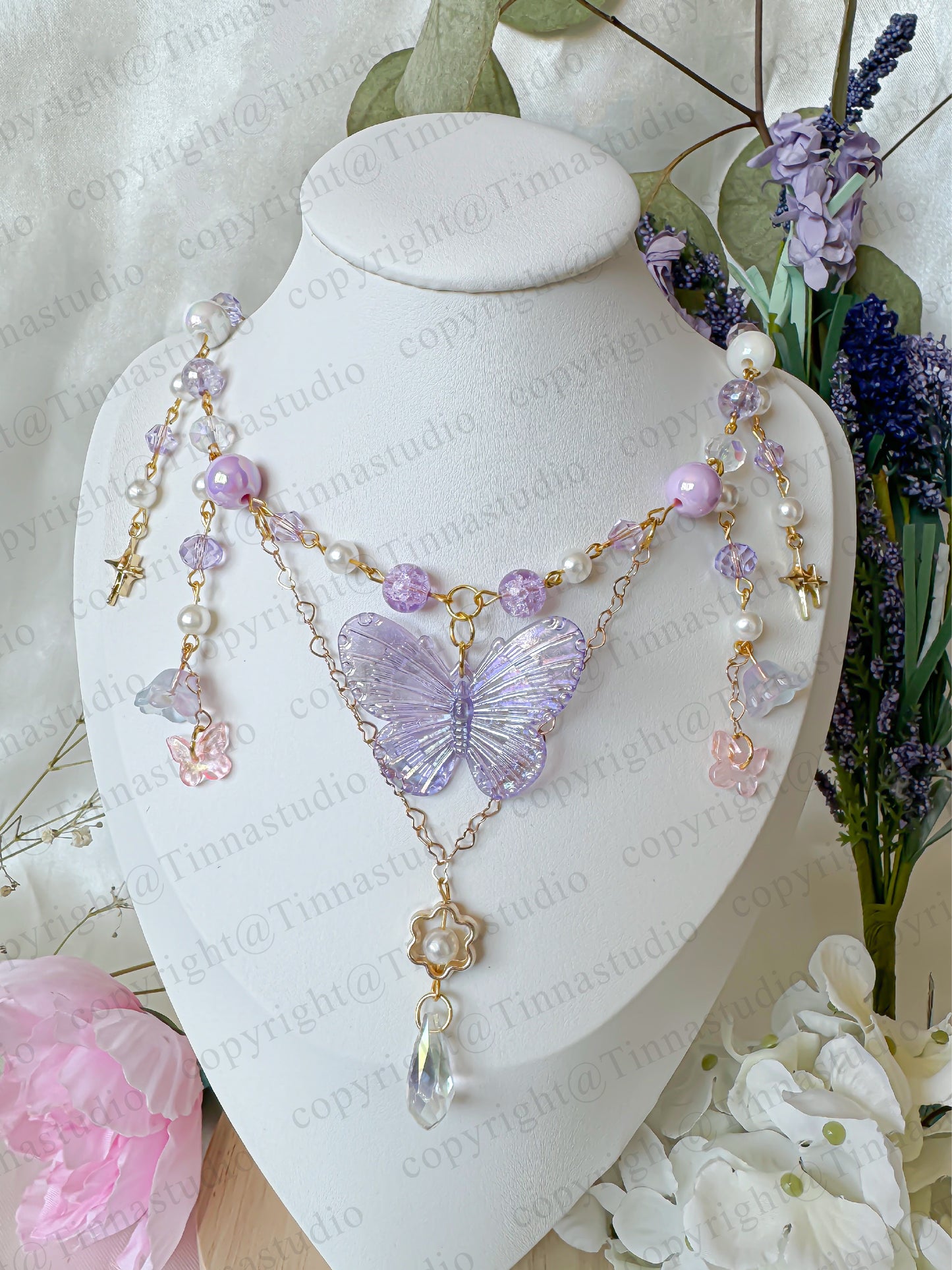 Purple version of the fairycore butterfly necklace on mannequin bust display.